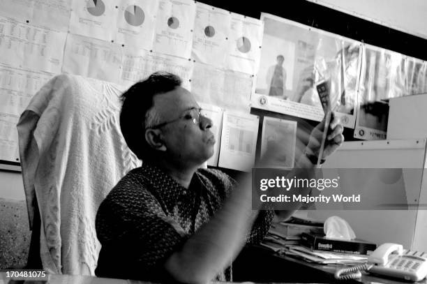 Dr. AKM Mushfiqur Rahman Faruq from the National TB Control Project, Shamoli, Dhaka, examines an X-ray of a suspected TB patient in his hospital...