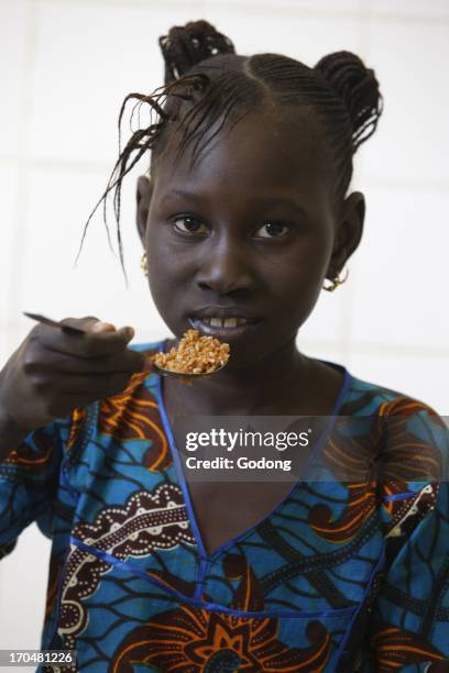 Fama Diop eating, Dakar, Senegal.