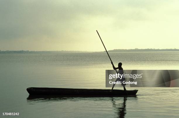 Boy rowing on Lake Togo, Aneho, Togo.