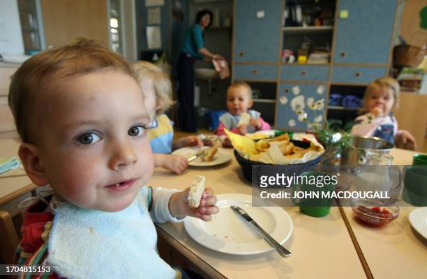 German toddlers of the "Frogs" group have breakfast at the Spreekita Kindergarten in Berlin 03 May 2007. AFP PHOTO JOHN MACDOUGALL