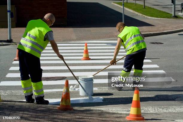 Men Painting Crosswalk Stripes.