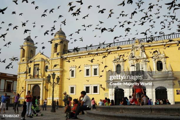 Pigeons are flying around the courtyard, in the San Francisco Cathedral which is also the museum of the colonial era catacombs. Lima, Peru. December...