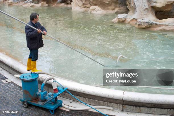 Cleaning Trevi Fountain, designed by Pietro da Cortona, Bernini and Nicola Salvi, is cleaned and emptied of coins three times each week in Rome.