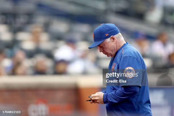 Manager Buck Showalter of the New York Mets heads back to the dugout in the seventh inning against the Miami Marlins during game one of a double...