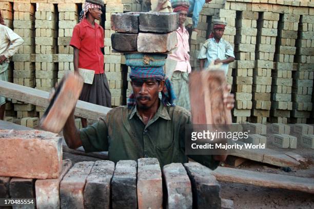 Workers at a brickfield in Chittagong, Bangladesh. There are 6000-7000 brickfields in Bangladesh, usually situated outside towns and cities in the...