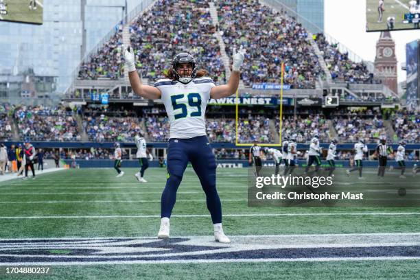 Jon Rhattigan of the Seattle Seahawks motions to the crowd in the end zone during the first half of a game against the Carolina Panthers at Lumen...
