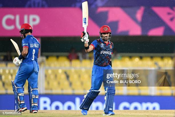 Afghanistan's Rahmanullah Gurbaz celebrates after scoring half century during a warm-up match between Afghanistan and Sri Lanka ahead of the ICC...