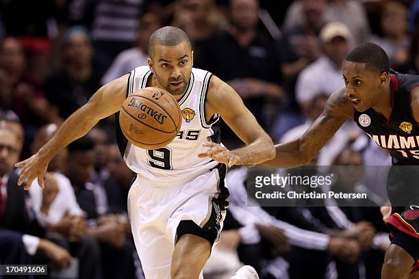 Tony Parker of the San Antonio Spurs brings the ball up court against Mario Chalmers of the Miami Heat in the first quarter during Game Four of the...