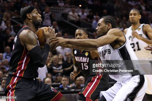 LeBron James of the Miami Heat with the ball against Kawhi Leonard of the San Antonio Spurs in the first quarter during Game Four of the 2013 NBA...