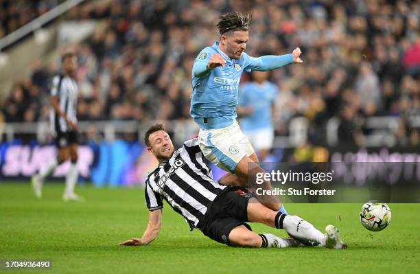 Manchester City player Jack Grealish is tackled by Paul Dummett during the Carabao Cup Third Round match between Newcastle United and Manchester...