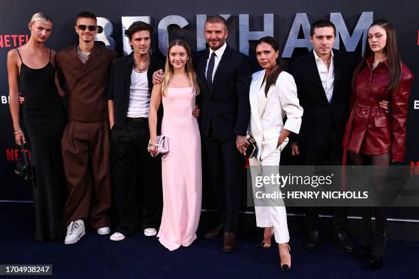 Former England footballer David Beckham and his wife Victoria Beckham pose on the red carpet with their children, and partners, Mia Regan, Romeo...