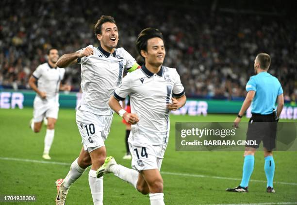 Real Sociedad's Spanish midfielder Mikel Oiarzabal and Real Sociedad's Japanese forward Takefusa Kubo celebrate during the UEFA Champions League...