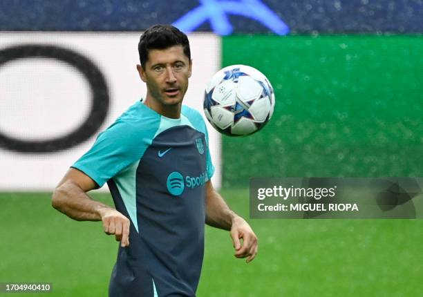 Barcelona's Polish forward Robert Lewandowski attends a training session at the Dragao stadium in Porto, on October 3 on the eve of the UEFA...