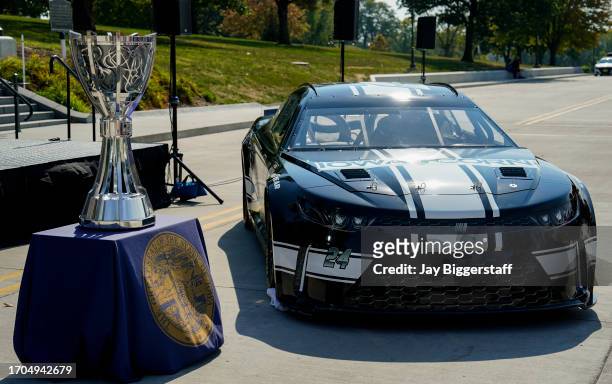 The NASCAR Bill France Cup is seen alongside an Iowa Speedway themed car during a NASCAR press conference at the Iowa State Capitol on October 3,...