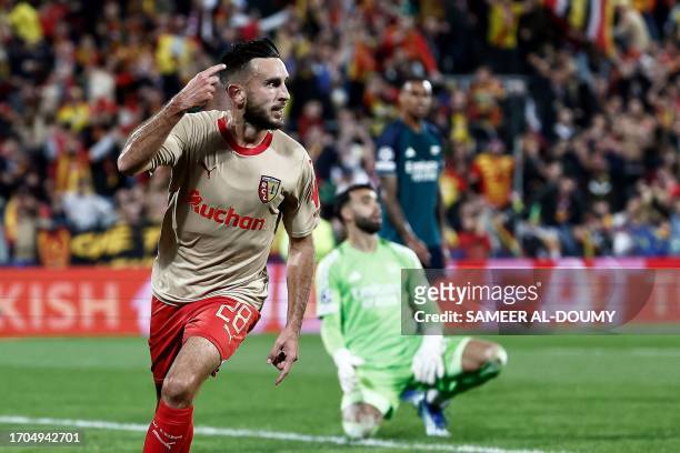 Lens' French midfielder Adrien Thomasson celebrates after scoring his team's first goal during the UEFA Champions League Group B first leg football...