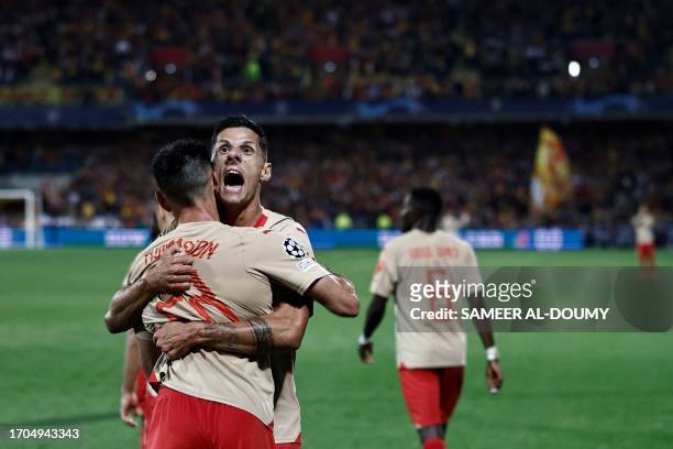 Lens' French midfielder Adrien Thomasson celebrates with Lens' French forward Florian Sotoca after scoring his team's first goal during the UEFA...