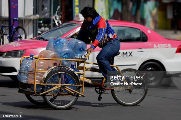 Water vendor on his tricycle crosses Tlahuac Avenue almost on the corner of the Periferico in Mexico City. In recent weeks, various groups of...