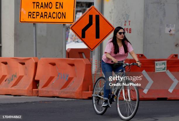 Woman on a bicycle crosses Av. Tlahuac and Periferico in Mexico City. In recent weeks, various groups of transport workers in Mexico City and the...