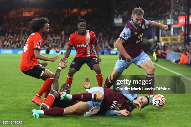 Marvelous Nakamba of Luton Town and Josh Brownhill of Burnley fall to the floor in a scramble for the ball during the Premier League match between...