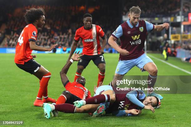Marvelous Nakamba of Luton Town and Josh Brownhill of Burnley fall to the floor in a scramble for the ball during the Premier League match between...