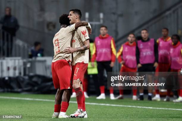 Lens' French forward Elye Wahi celebrates with Lens' French forward Florian Sotoca after scoring his team's second goal during the UEFA Champions...