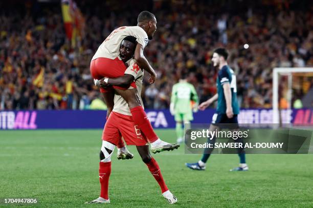 Lens' French midfielder Andy Diouf celebrates with Lens' Ghanaian midfielder Salis Abdul Samed after winning the UEFA Champions League Group B first...