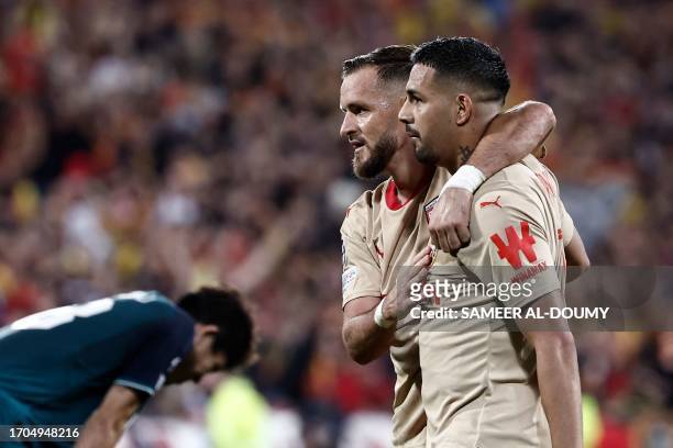 Lens' French defender Jonathan Gradit celebrates with Lens' Argentine defender Facundo Medina after winning the UEFA Champions League Group B first...