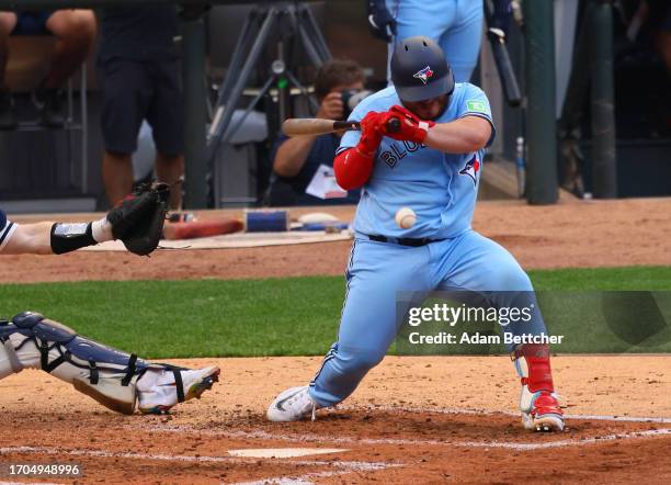 Alejandro Kirk of the Toronto Blue Jays gets hit with the pitch in the fourth inning against the Minnesota Twins during Game One of the Wild Card...