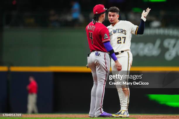 Willy Adames of the Milwaukee Brewers and Ketel Marte of the Arizona Diamondbacks talk on the field in the third inning during Game 1 of the Wild...