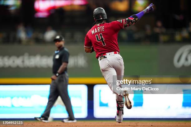 Ketel Marte of the Arizona Diamondbacks reacts while rounding the bases after hitting a solo home run in the third inning during Game 1 of the Wild...