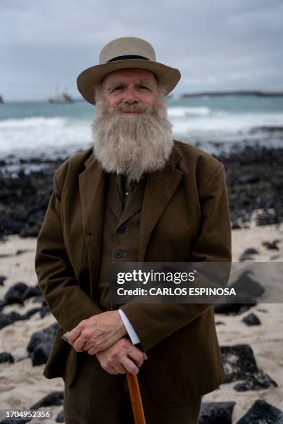 Kenneth Noll, in the costume of the English naturalist, geologist, and biologist Charles Robert Darwin, poses for a picture at the beach in Puerto...