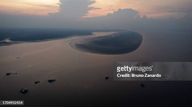 Aerial view of the historic low tide that the Amazon has been experiencing has left part of the Rio Negro dry and with an extensive strip of land...