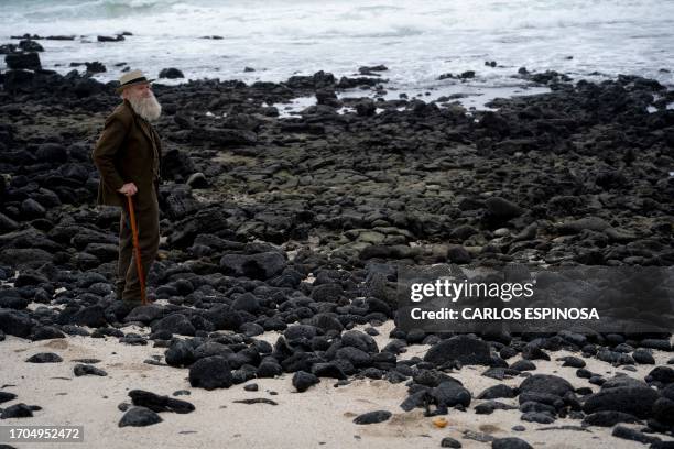 Kenneth Noll, in the costume of the English naturalist, geologist, and biologist Charles Robert Darwin, poses for a picture at the beach in Puerto...