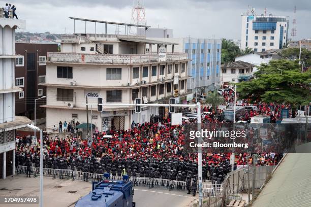 Police officers form a barricade in front of demonstrators during the 'Occupy Bank of Ghana' protest in Accra, Ghana, on Tuesday, Oct. 3, 2023. The...
