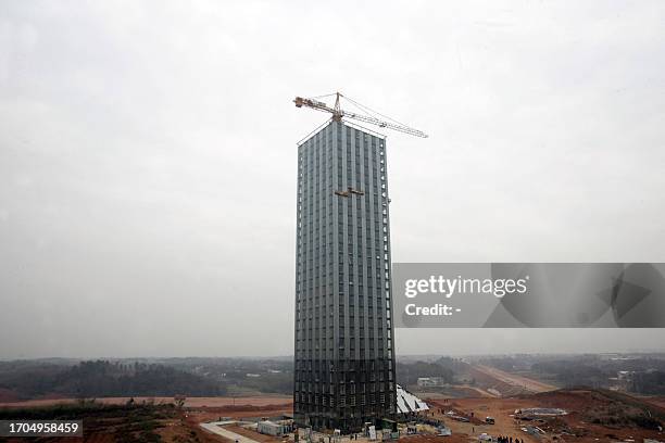 This photo taken on December 26, 2011 shows a 30-story hotel building of China's Board Group under constrcution near the Dongting lake in Changsha,...