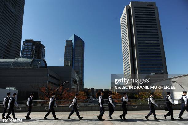 Japanese policeman cross a foot overbridge near the venue ahead of the Asia-Pacific Economic Cooperation forum in Yokohama on November 11, 2010. APEC...