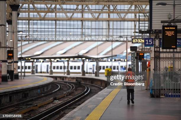 An employee walks along an empty platform during a strike by train drivers at Waterloo railway station in London, UK, on Wednesday, Oct. 4, 2023....