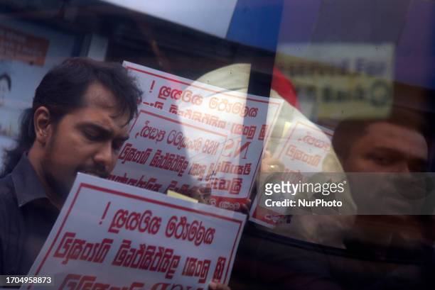 Reflection seen Members of Ceylon Bank Employees Union protest in front of Sri Lanka Savings Bank, They demand don't merge National Savings Bank and...