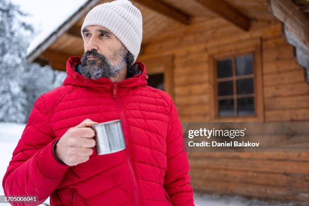 cabin getaway. man enjoys a log cabin retreat. - plastfritt bildbanksfoton och bilder