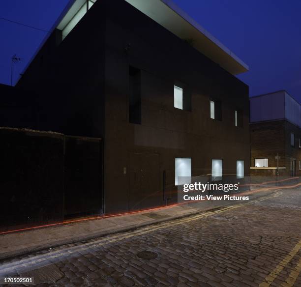 View of West elevation, from Chance Street, with car light trails, Dirty House, London, United Kingdom, Architect: Adjaye Associates, 2002.