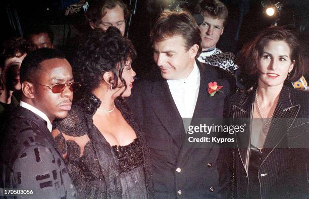Singers Bobby Brown and Whitney Houston, and actor Kevin Costner with his wife Cindy Costner attend 'The Bodyguard' Hollywood premiere on November...