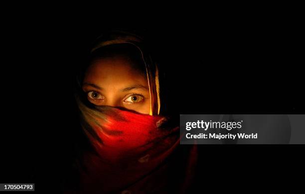 Portrait of a lady in the dark at a studio in Kolkata, India. April 7, 2007.