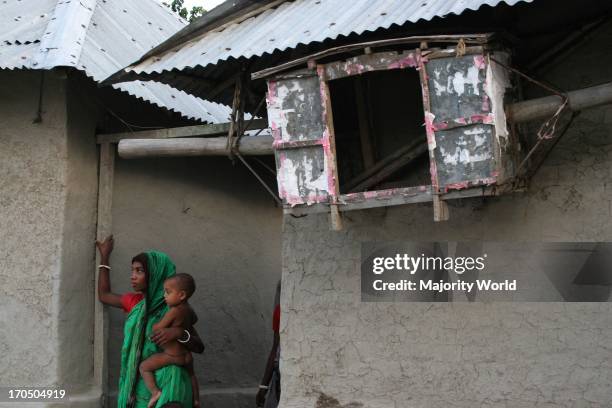 Family members of a Palanquin porters group passing their idle time. Palanquins are still used for carrying brides in remote Bangladesh. In Mathbari,...