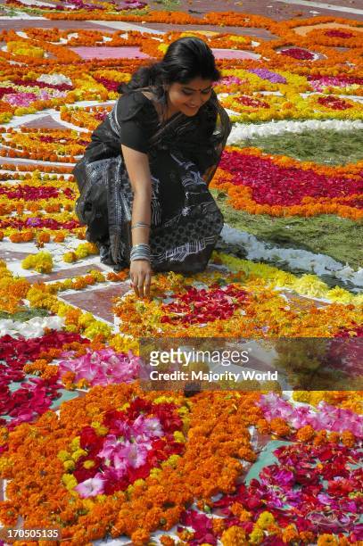Girl places flowers at the Central Shahid Minar in Dhaka, the monument for the martyrs of the 1952 language movement, on International Mother...