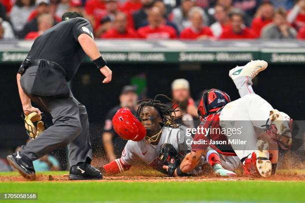 Home plate umpire Sean Barber watches as Elly De La Cruz of the Cincinnati Reds is tagged out at home by catcher Cam Gallagher of the Cleveland...