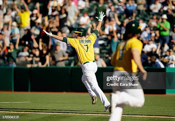 Nate Freiman of the Oakland Athletics celebrates as he runs up the first base line after he hit a single that scored John Jaso in the bottom of the...