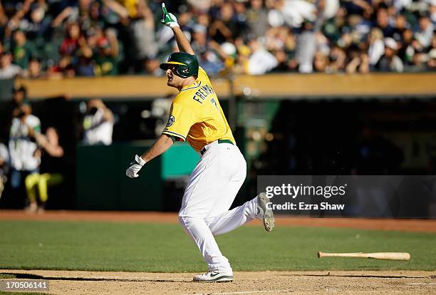 Nate Freiman of the Oakland Athletics celebrates as he runs up the first base line after he hit a single that scored John Jaso in the bottom of the...