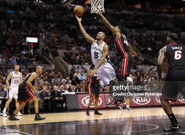 Tony Parker of the San Antonio Spurs lays the ball up against Udonis Haslem of the Miami Heat in the first half during Game Four of the 2013 NBA...