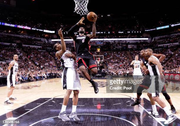 LeBron James of the Miami Heat goes up for a shot against Kawhi Leonard of the San Antonio Spurs in the first half during Game Four of the 2013 NBA...