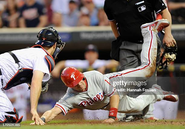 Michael Young of the Philadelphia Phillies is out as Joe Mauer of the Minnesota Twins defends home plate during the sixth inning of the game on June...